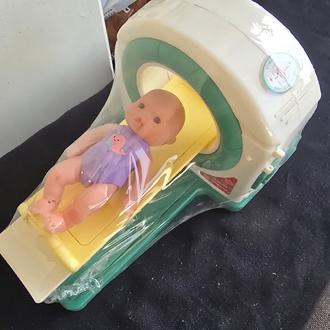 Doll and MRI machine (battery flap missing)